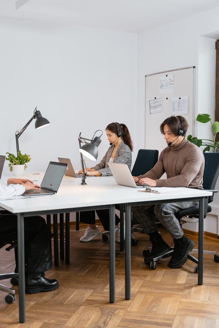 Business call center team focused on customer service with modern office setup.